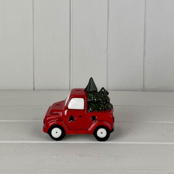Small LED red ceramic Christmas truck on a white wooden shelf