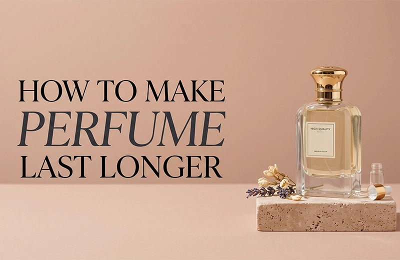 Gold-capped glass perfume bottle on a stone block with dried flowers and lavender against a blush pink wall