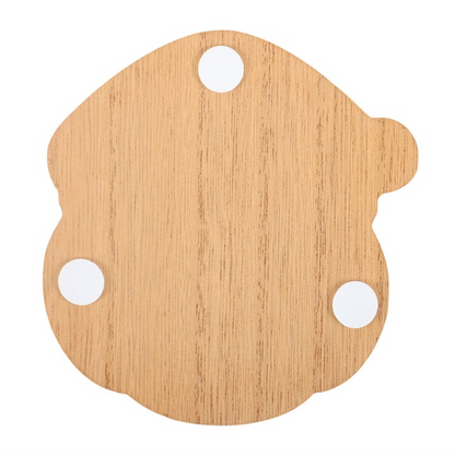 Back of a Santa-shaped wooden coaster with small pads