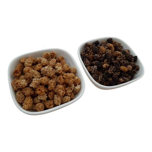 Dried white mulberries and dried black mulberries in two white dishes