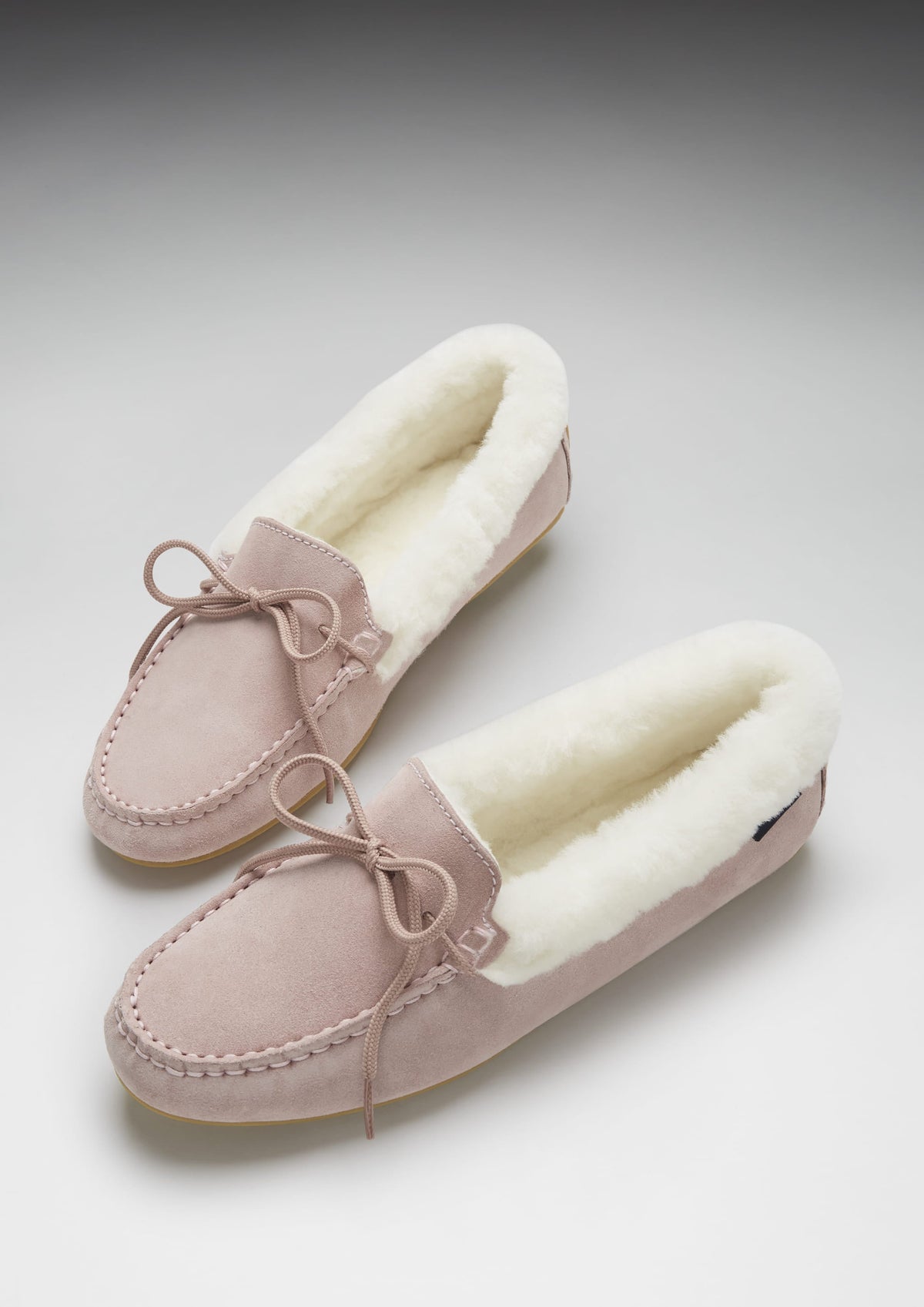 Hugs & Co. women's ice pink suede moccasin slippers with sheepskin lining and bow