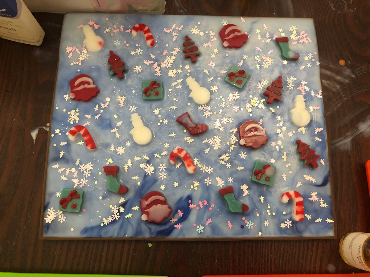 Christmas wax melt slab decorated with Santas, trees, stockings and candy canes