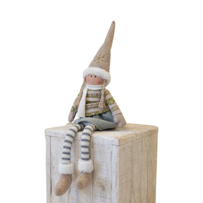 Fabric Christmas girl doll in natural felt hat and Fair Isle-style jumper sitting on a wooden crate