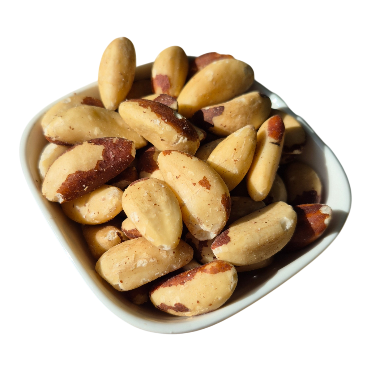 Whole natural Brazil nuts in a white dish