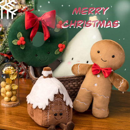 Wreath, snowy gingerbread house, tree and gingerbread man Christmas plush toys together