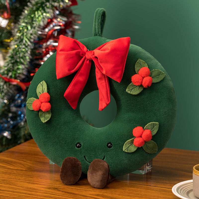 Green Christmas wreath plush with red bow, berries and a smiling face