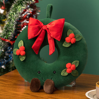 Green Christmas wreath plush with red bow, berries and a smiling face
