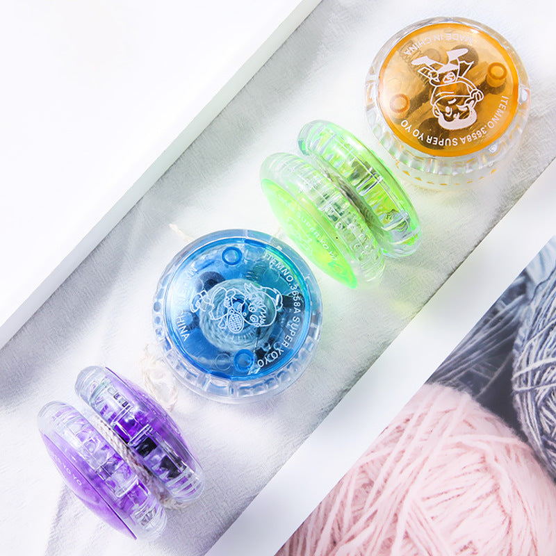 Light-up plastic yo-yos in four colours on a white surface