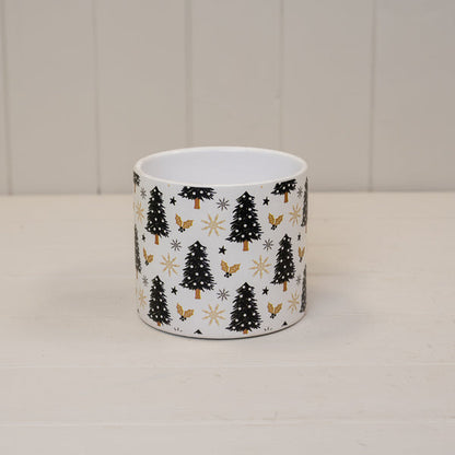 Black and gold Christmas tree print pot on a white shelf