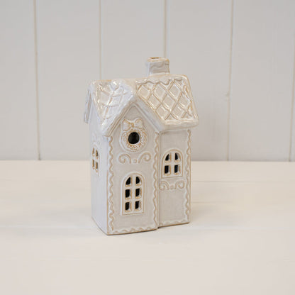 Large cream ceramic Christmas townhouse with lattice roof and wreath detail
